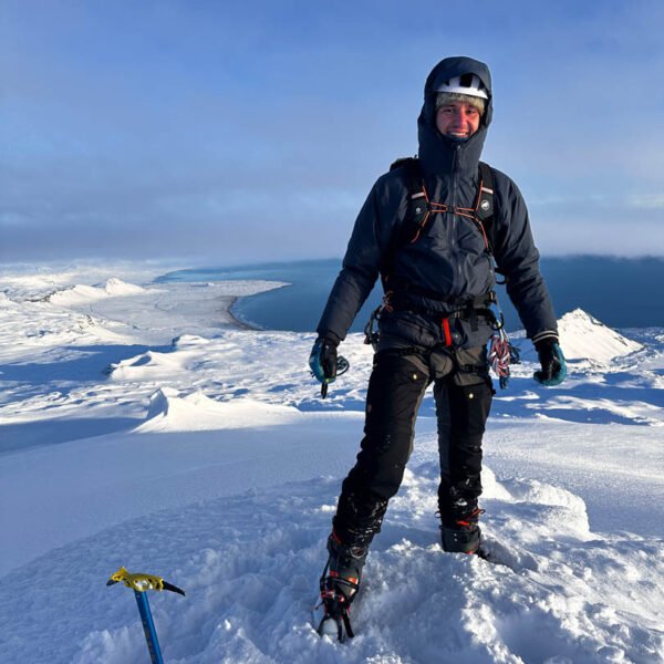 hiker summiting snæfellsjökull, glacier hike in iceland
