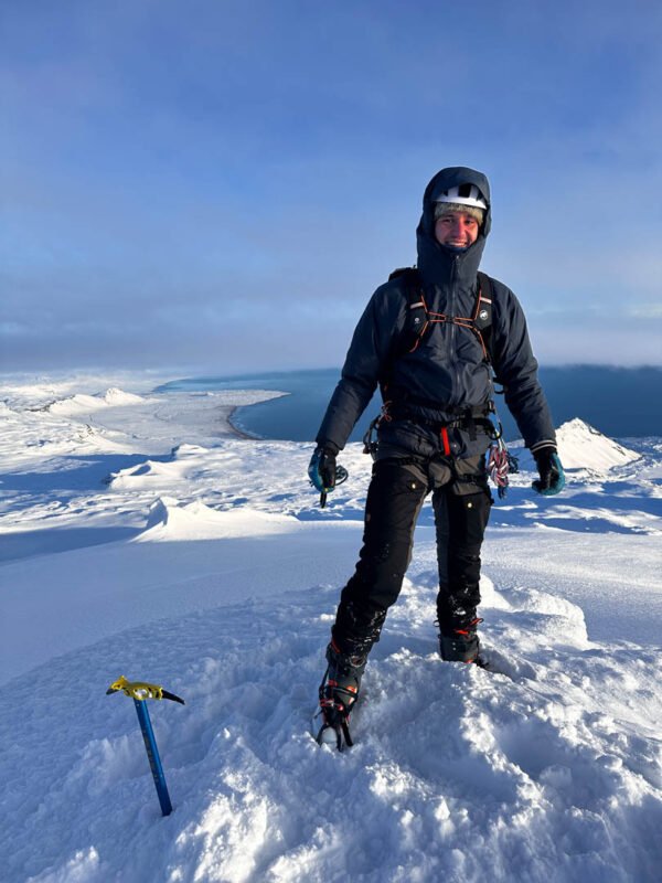 hiker summiting snæfellsjökull, glacier hike in iceland