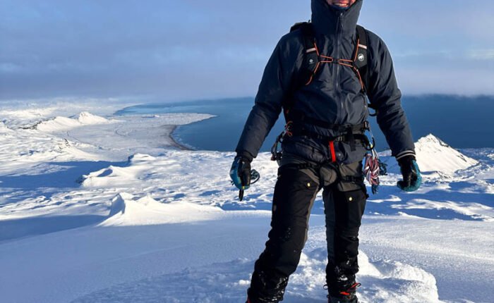 hiker summiting snæfellsjökull, glacier hike in iceland