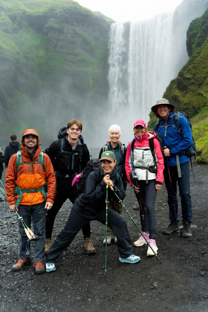 Group of hikers at the start of the Fimmvörðuháls trail above Skógafoss