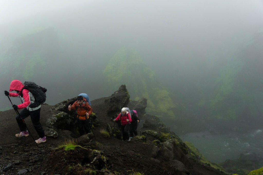 Four hikers on the Fimmvörðuháls trail in misty weather